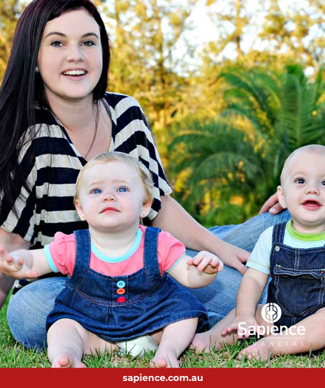 young family sitting on grass