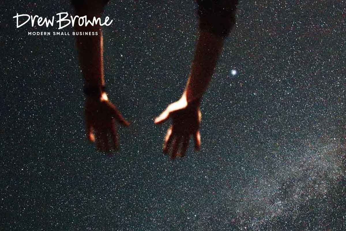 arms reaching up to the stars on a clear night