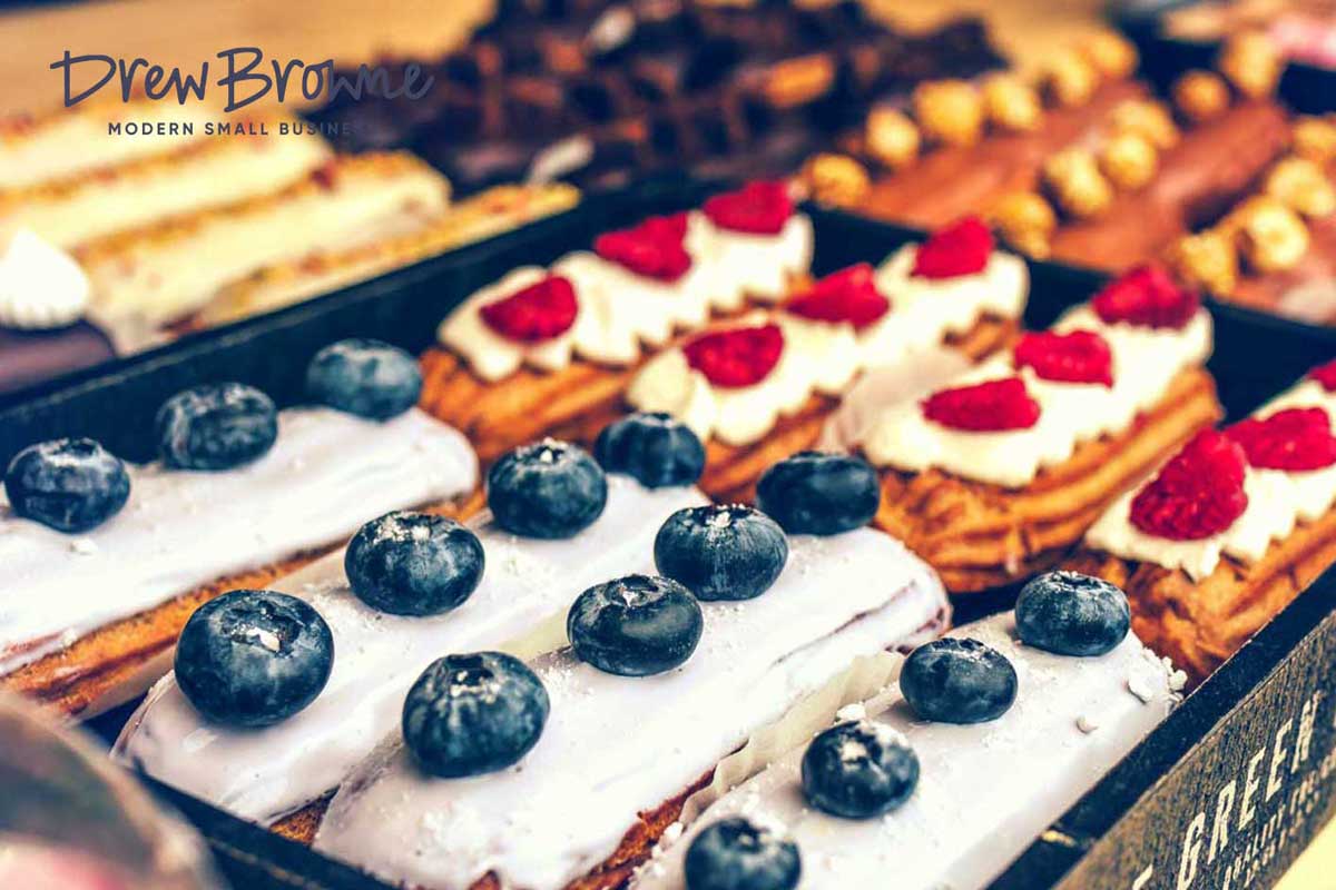A close up view of a French patisserie cake shop with berries and icing
