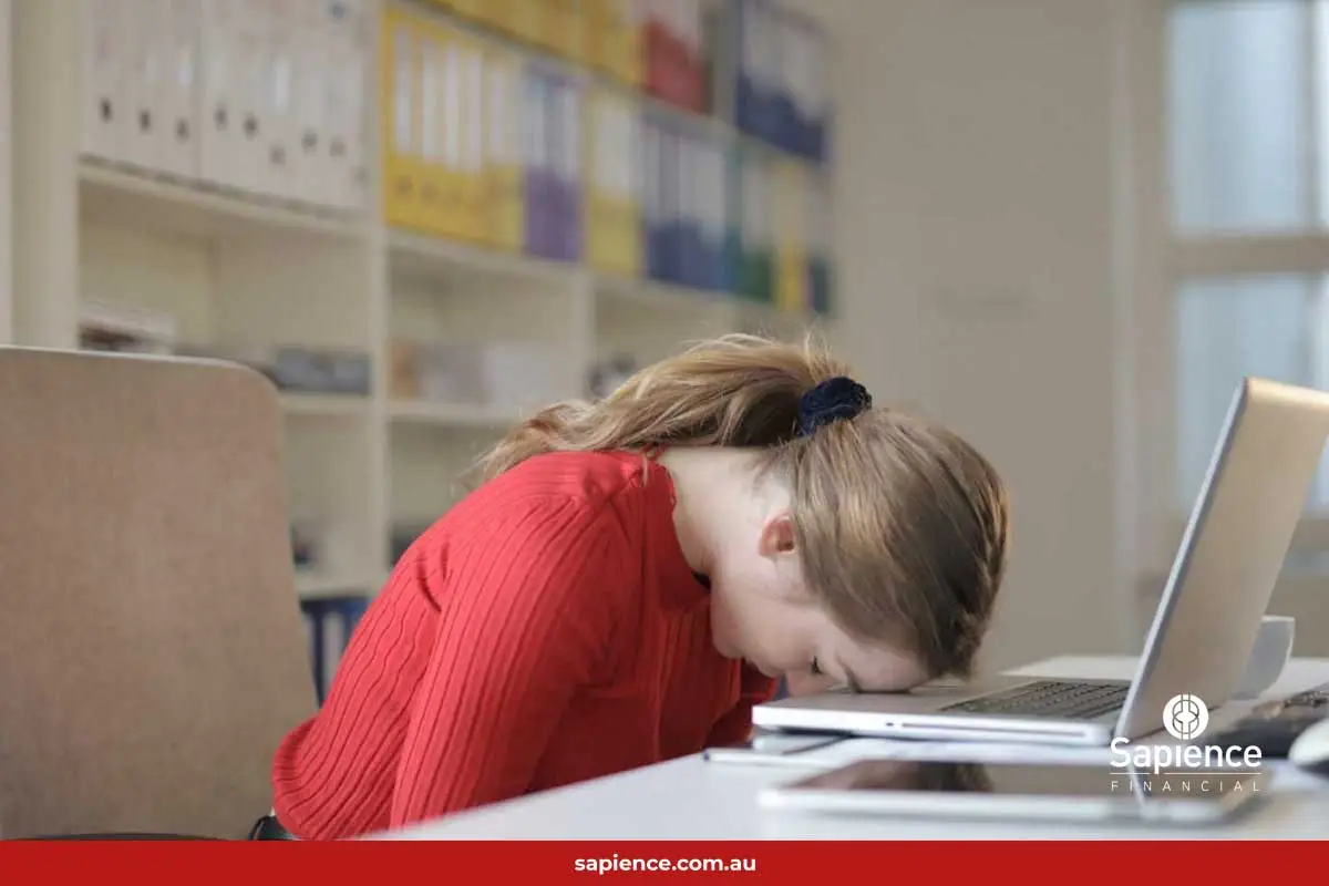 exhausted lady with forehead resting on laptop keyboard