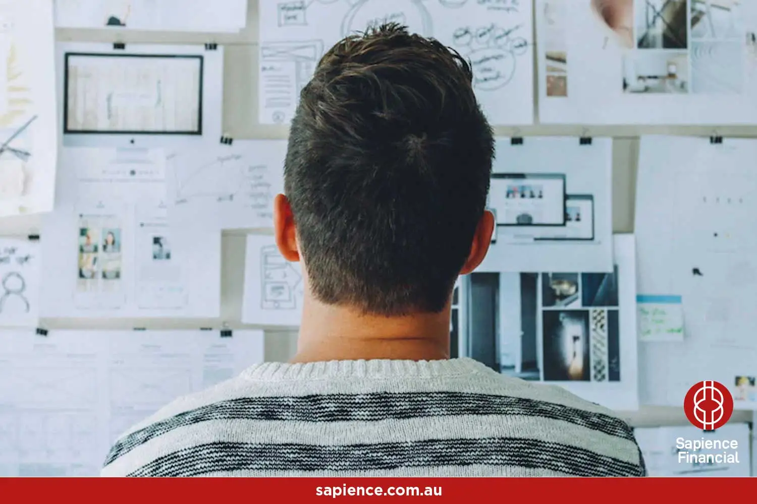 business owner looking at wall of numbers and charts