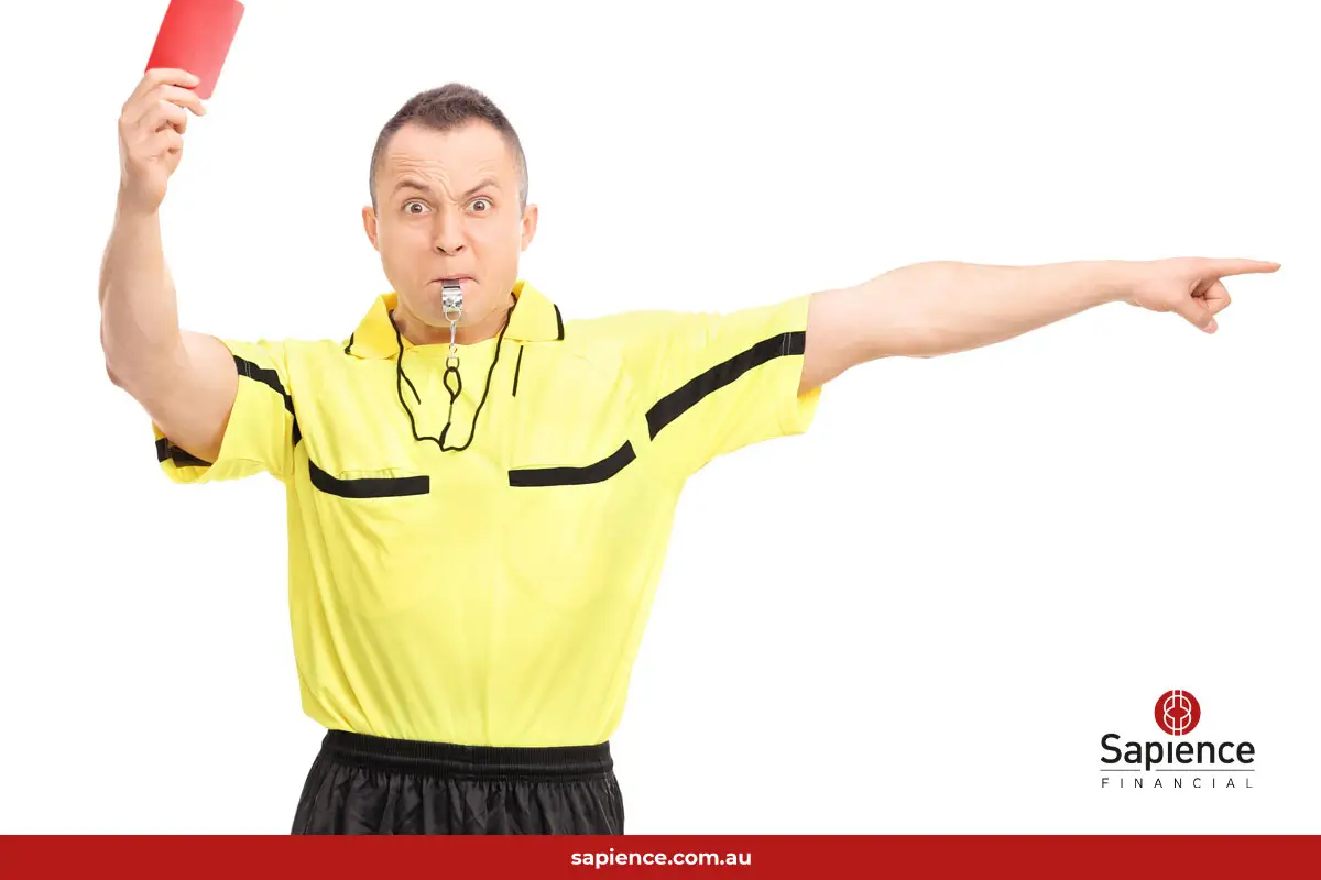 angry soccer referee blowing whistle and showing a red card