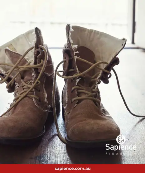 old work boots on wooden floor
