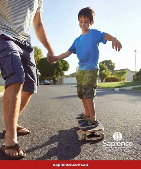 child learning to ride skateboard