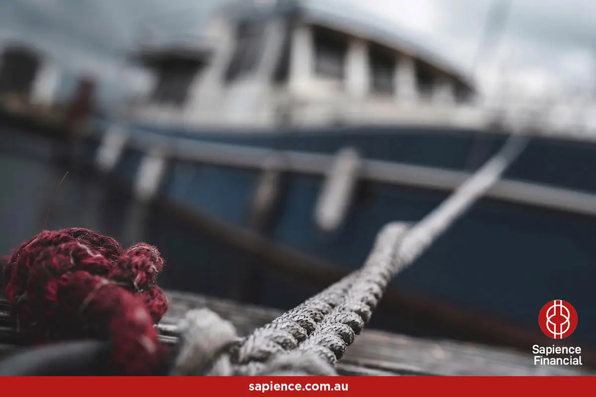 sea going vessel roped to the dock straining at the mooring ropes