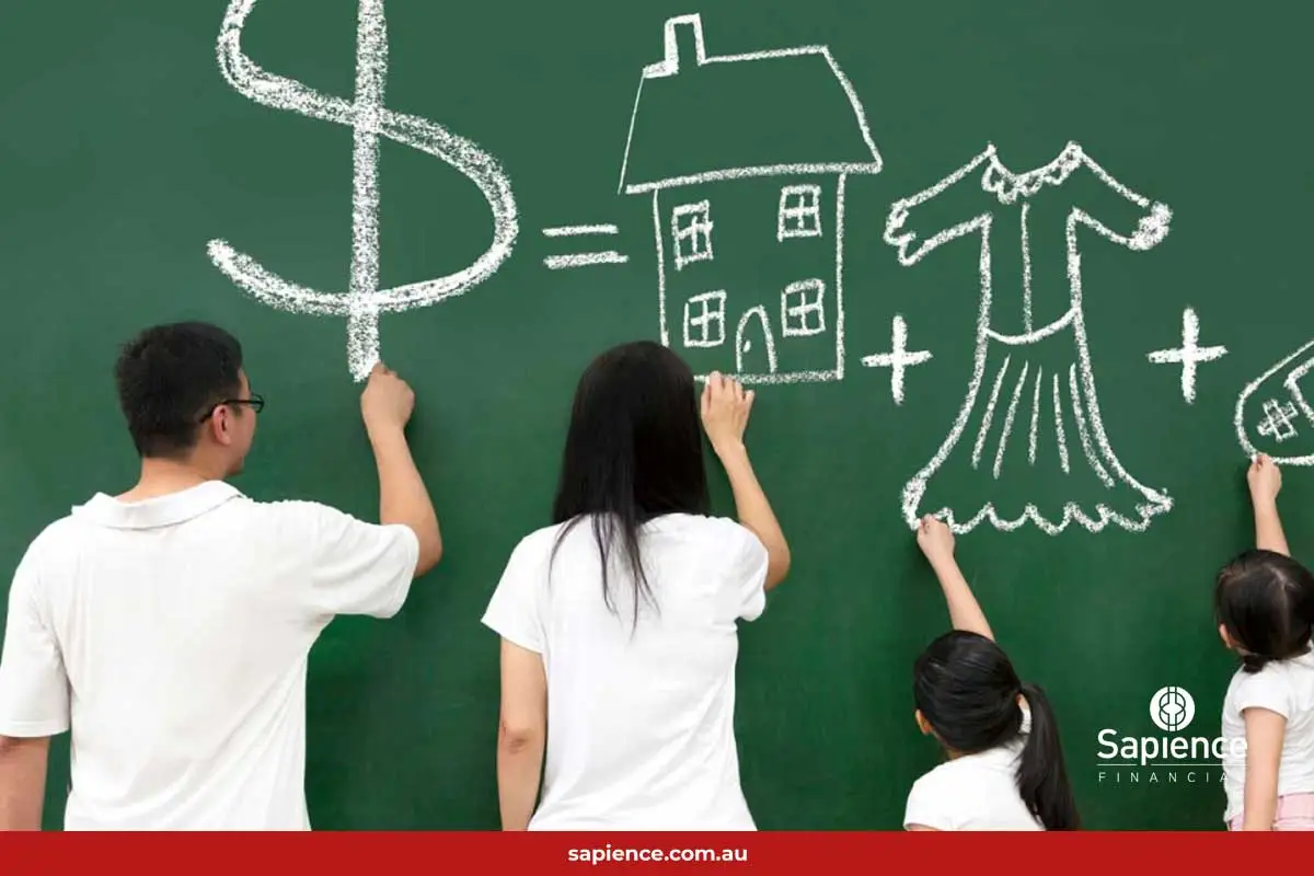 parents and children drawing on chalk board